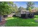 Exterior photo captures the backyard's expansive lawn, mature trees, and gray wooden deck at 2121 Arlington Ne Ave, Atlanta, GA 30324