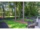 Exterior shot of backyard featuring a lush green lawn, mature trees and gray painted deck at 2121 Arlington Ne Ave, Atlanta, GA 30324