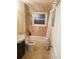 Tiled bathroom featuring a sink, toilet, bathtub with shower, and a window for natural light at 2121 Arlington Ne Ave, Atlanta, GA 30324