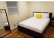 Cozy bedroom with hardwood floors, closet, and a queen sized bed with a yellow accent pillow at 2121 Arlington Ne Ave, Atlanta, GA 30324