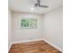 Neutral bedroom featuring a ceiling fan and hardwood flooring, with a window bringing in natural light at 2121 Arlington Ne Ave, Atlanta, GA 30324