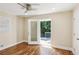 Bedroom featuring hardwood floors and an exterior door leading to a deck space at 2121 Arlington Ne Ave, Atlanta, GA 30324