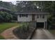Charming single-story home with a stone accent wall and driveway parking at 2121 Arlington Ne Ave, Atlanta, GA 30324
