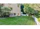 Large grassy backyard with mature trees and white fence at 2269 E Cherokee Dr, Woodstock, GA 30188