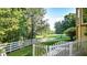 Landscaped backyard with white fence and open space at 2269 E Cherokee Dr, Woodstock, GA 30188