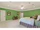 Bright bedroom with green walls, a comfortable bed, and hardwood floors at 2269 E Cherokee Dr, Woodstock, GA 30188