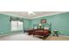 Light teal bedroom with twin beds and plantation shutters at 2269 E Cherokee Dr, Woodstock, GA 30188