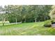 Expansive lawn with mature trees and white fence at 2269 E Cherokee Dr, Woodstock, GA 30188