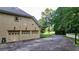 Three-car garage with tan doors and a basketball goal at 2269 E Cherokee Dr, Woodstock, GA 30188