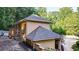 Tan house with gray roof, white fence, and landscaping at 2269 E Cherokee Dr, Woodstock, GA 30188