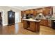 Large kitchen with an island, granite countertops, and dark wood cabinets at 2269 E Cherokee Dr, Woodstock, GA 30188
