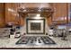 Kitchen detail showing gas cooktop, granite counters, and decorative tile backsplash at 2269 E Cherokee Dr, Woodstock, GA 30188