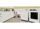 Laundry room with washer, dryer, cabinets, and utility sink at 2269 E Cherokee Dr, Woodstock, GA 30188