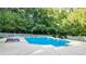 Relaxing pool area surrounded by trees at 2269 E Cherokee Dr, Woodstock, GA 30188