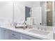 Bathroom with double vanity, quartz countertops, and gray cabinets at 3315 Stillwood Ln, Atlanta, GA 30354
