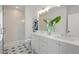 Double vanity bathroom with gray cabinets, quartz countertops, and patterned floor at 3315 Stillwood Ln, Atlanta, GA 30354