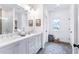 Double vanity bathroom with gray cabinets, quartz countertops, and a walk-in shower at 3315 Stillwood Ln, Atlanta, GA 30354