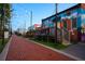 Image shows a brick walkway with string lights and art in a vibrant community setting at 3315 Stillwood Ln, Atlanta, GA 30354