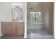 Modern bathroom featuring wood-look vanity, glass shower and shower seat at 8200 Main St # 1206, Woodstock, GA 30188