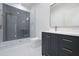 Modern bathroom features a sleek vanity with stone countertop and a frameless glass shower with herringbone tile at 8200 Main St # 1206, Woodstock, GA 30188
