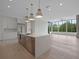 Modern kitchen boasts a large island with quartz countertop, stainless steel appliances, and hardwood flooring at 8200 Main St # 1206, Woodstock, GA 30188