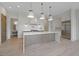 Open concept kitchen features a large island with white countertops, stainless steel appliances, and hardwood flooring at 8200 Main St # 1206, Woodstock, GA 30188