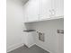 Laundry room with white cabinets, dark countertop, tile flooring, and a washing machine hook up at 8200 Main St # 1206, Woodstock, GA 30188