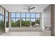 Bright living room featuring a modern fireplace, ceiling fan, and large windows with a scenic view at 8200 Main St # 1206, Woodstock, GA 30188