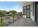Open air patio overlooking the neighborhood, featuring dark railings, wood deck, and black framed windows at 8200 Main St # 1206, Woodstock, GA 30188
