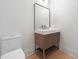 Modern powder room features a sleek vanity with a unique design and a minimalist mirror at 8200 Main St # 1206, Woodstock, GA 30188