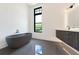 Sleek bathroom features a modern standalone tub, black trim windows, and a floating vanity at 8200 Main S St # 1208, Woodstock, GA 30188