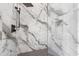 Modern bathroom features a spacious glass shower with marble-style tile and a rain shower head at 8200 Main S St # 1208, Woodstock, GA 30188
