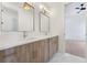 Well-lit bathroom with double vanity, modern fixtures, and a view into the bedroom at 8200 Main S St # 1208, Woodstock, GA 30188