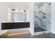 Bathroom featuring a double vanity, a sleek glass shower with marble surround, and modern lighting at 8200 Main S St # 1208, Woodstock, GA 30188