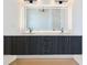 Bathroom featuring a double vanity with modern lighting fixtures and stylish gray wood cabinets at 8200 Main S St # 1208, Woodstock, GA 30188