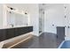 Bathroom with double vanity, marble shower, and modern lighting fixtures above the mirror at 8200 Main S St # 1208, Woodstock, GA 30188