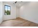 Bright bedroom showcases hardwood floors, a black-trimmed window, and neutral decor at 8200 Main S St # 1208, Woodstock, GA 30188