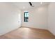 Clean bedroom with hardwood floors, a black-trimmed window with a view, and neutral decor at 8200 Main S St # 1208, Woodstock, GA 30188