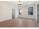 Light-filled bedroom featuring hardwood floors, large windows, and a modern chandelier at 8200 Main S St # 1208, Woodstock, GA 30188
