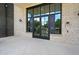 Inviting building entrance with double doors, large windows, and brick facade at 8200 Main S St # 1208, Woodstock, GA 30188