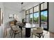 Modern dining room with large windows, stylish lighting, and seating for six at 8200 Main S St # 1208, Woodstock, GA 30188