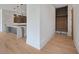 Inviting entryway that flows into the kitchen with an island and wood-look floors at 8200 Main S St # 1208, Woodstock, GA 30188