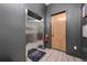 Hallway with elevator access and a door leading to unit 1208, featuring wood-look floors at 8200 Main S St # 1208, Woodstock, GA 30188