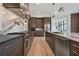 Open kitchen featuring stainless steel appliances, custom cabinets, and an expansive island at 8200 Main S St # 1208, Woodstock, GA 30188