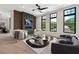 Inviting living room with a fireplace, accent wall, large windows, and stylish decor at 8200 Main S St # 1208, Woodstock, GA 30188