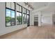 Bright living room features large windows, light hardwood floors and modern lighting fixture at 8200 Main S St # 1208, Woodstock, GA 30188