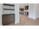 Light-filled living room showcases a built-in cabinet, shelves and light hardwood floors at 8200 Main S St # 1208, Woodstock, GA 30188
