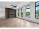 Open concept living room with a fireplace, hardwood flooring, and natural light at 8200 Main S St # 1208, Woodstock, GA 30188