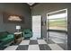 Stylish lobby with elevator, emerald chairs, modern art, and patterned flooring at 8200 Main S St # 1208, Woodstock, GA 30188