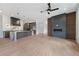 Open concept with a stylish kitchen featuring a large island and a modern fireplace accent wall at 8200 Main S St # 1208, Woodstock, GA 30188